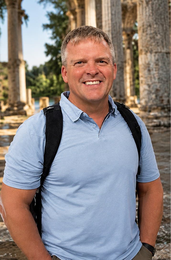 Portrait of Robert Upton standing among stone columns
